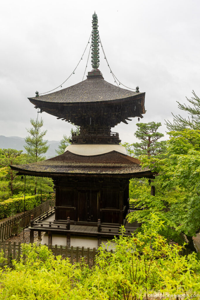 The Tahoto pagoda of Jojakkoji surrounded by summer greenery under cloudy sky, Arashiyama, Kyoto