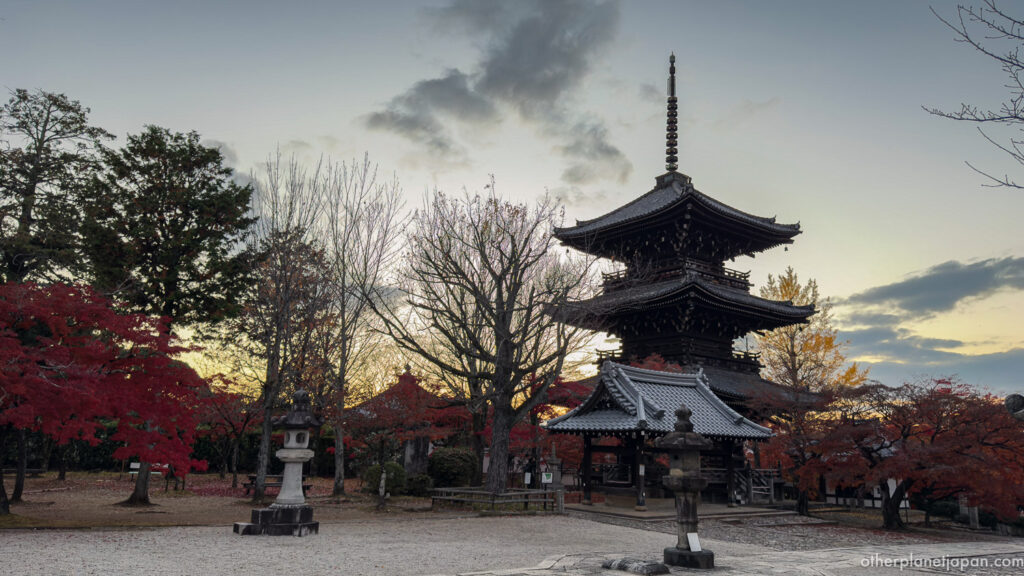Three-story pagoda silhouetted against autumn sky at Shinnyodo Temple at sunset