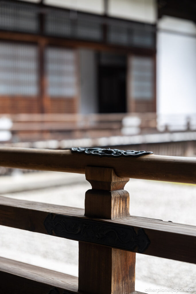 An intricately cast iron fitting decorates the wooden railing of Nanzenji Hojo, an example of early Edo-period craftsmanship preserved at the Kyoto temple.