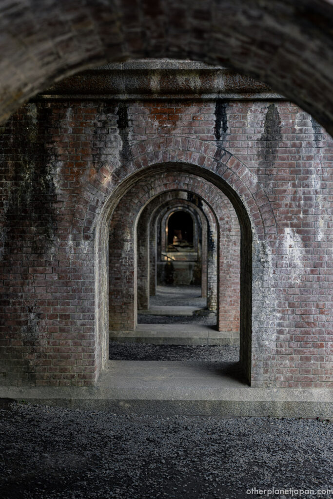 The brick arches of the Suirokaku aqueduct recede into shadow at Nanzenji, a Meiji-period engineering work still in use today in Kyoto.