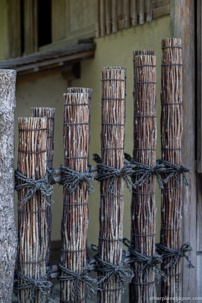 Bundled-twig fence bound with wire and rope in front of Sekkatei tea house at Kinkakuji, Kyoto