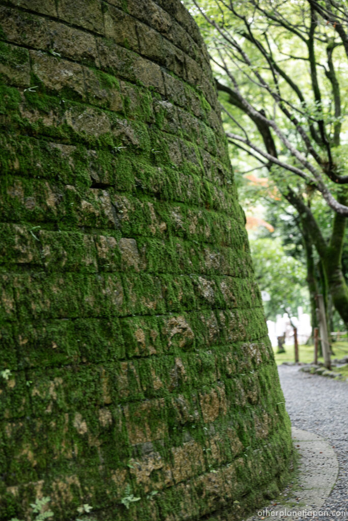 Wild moss covering the curved stone wall of the stupa at Adashino Nenbutsuji