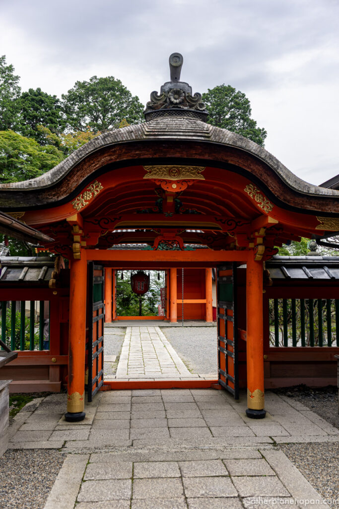 Ornate vermilion and gold karahafu entrance canopy of Bishamondo Temple main hall in Kyoto