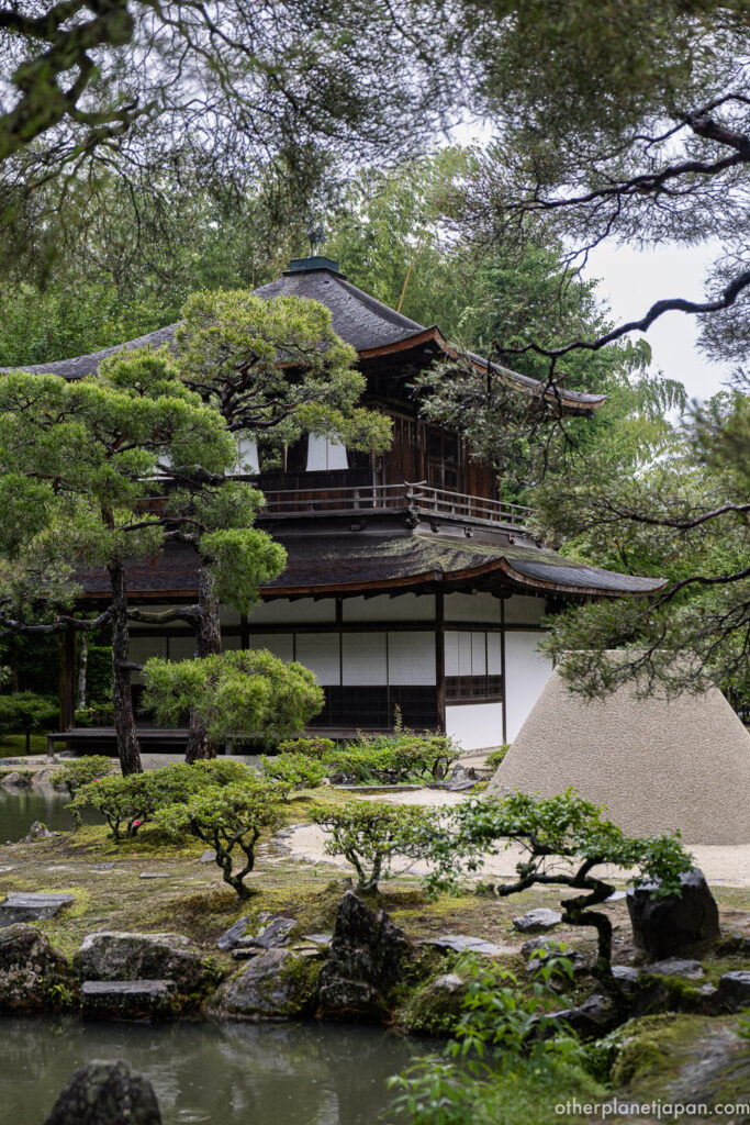 The kogetsudai sand cone rising from the raked garden before the Silver Pavilion under a grey sky at Ginkakuji, Kyoto"