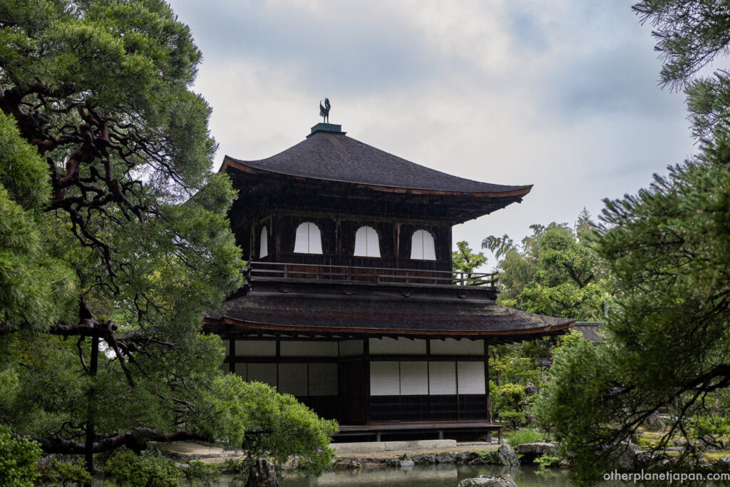 Ginkakuji Silver Pavilion rising above a garden pond on a rainy day in Kyoto, Japan