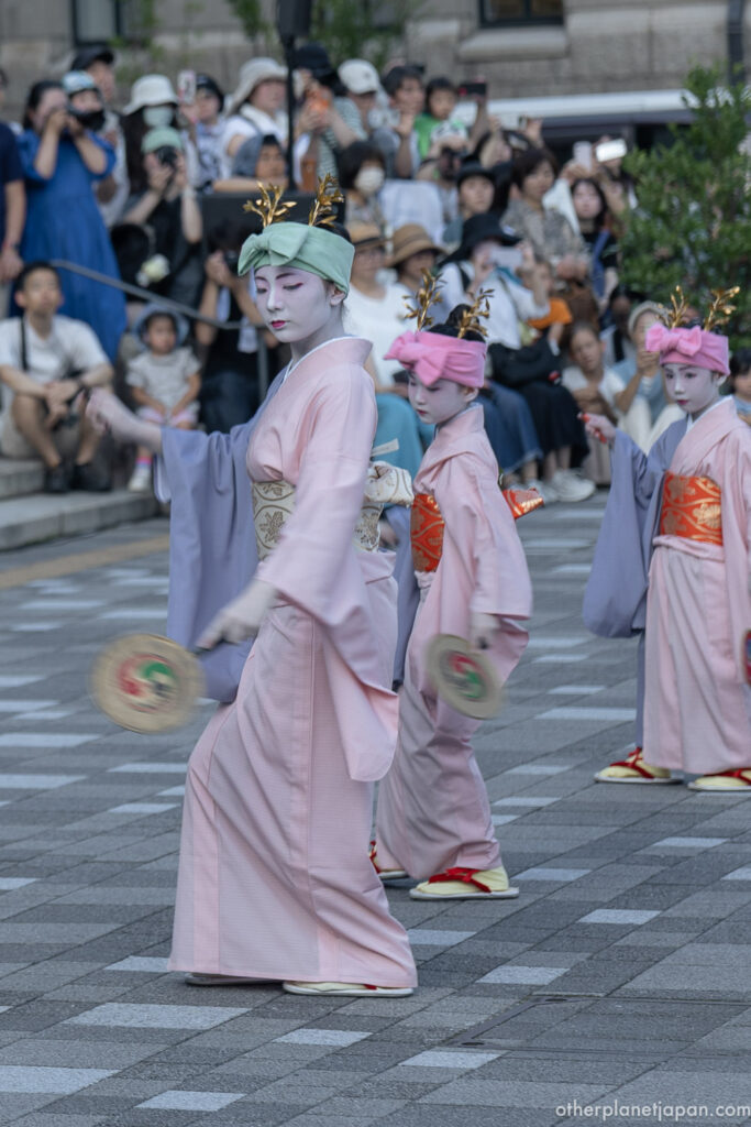 Young dancers in pink kimono with drums performing during Gion Matsuri