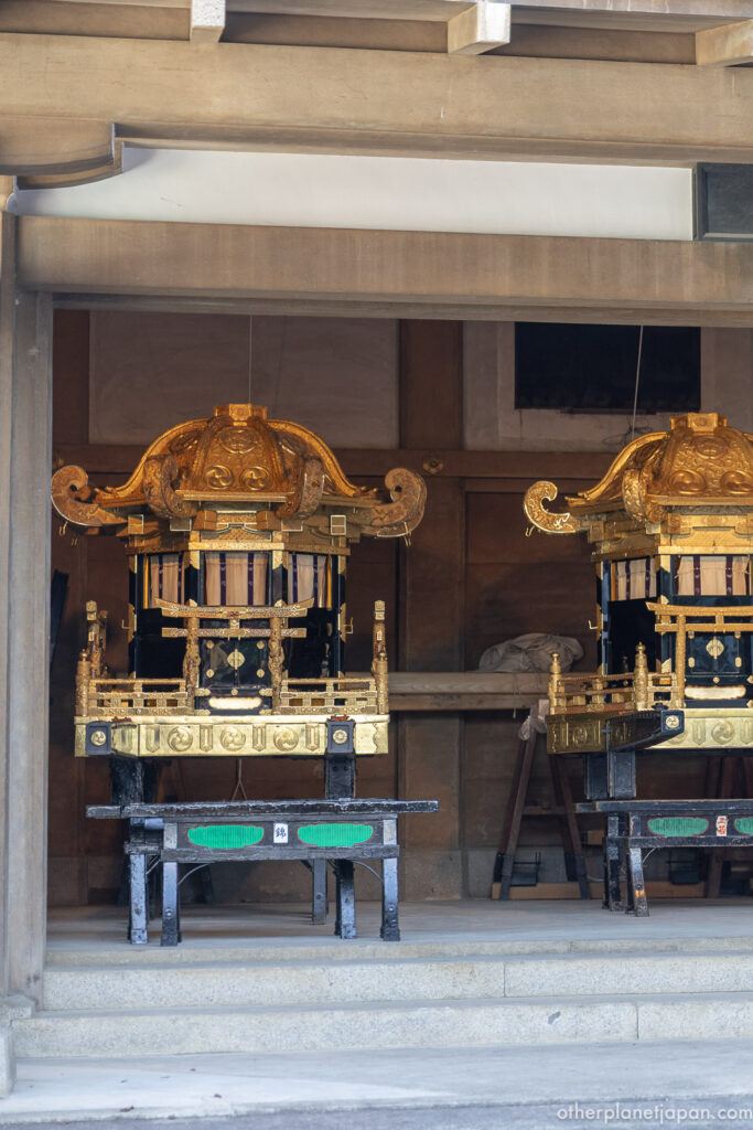 Golden mikoshi portable shrines of Yasaka Shrine resting in their storehouse before Gion Matsuri]