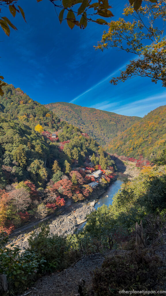 Autumn foliage covering the Hozu River valley seen from the Arashiyama Park observation deck