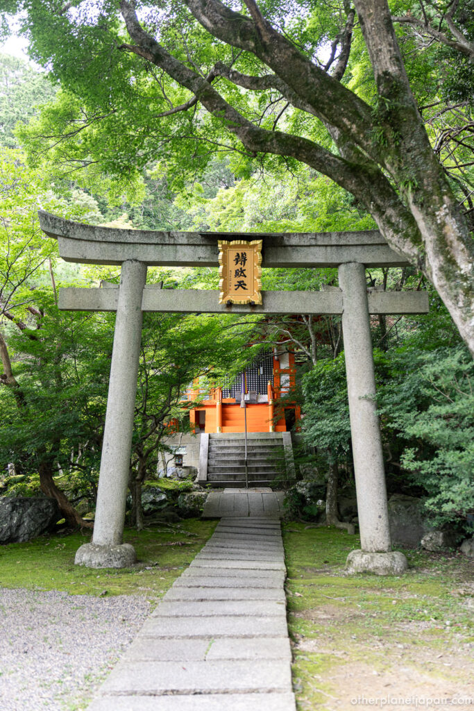 Stone torii gate inscribed for Benzaiten leading to a vermilion shrine hall inside Bishamondo Temple, Kyoto