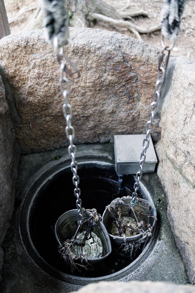 An old stone well at Himuro Shrine in Nara, with buckets still hanging on chains