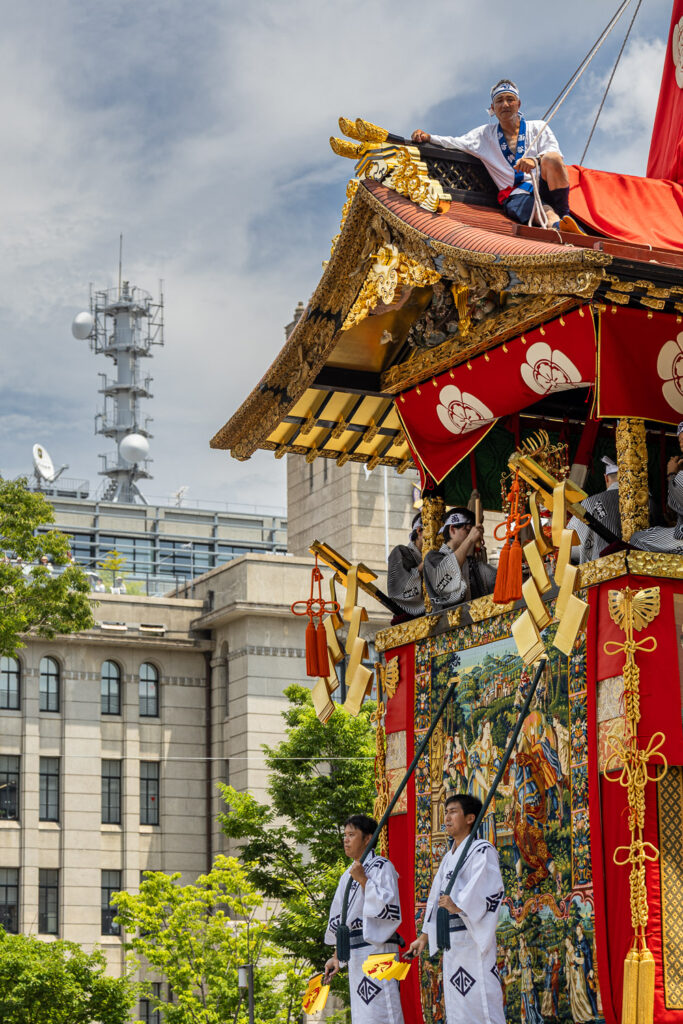 A Gion Matsuri float passing Kyoto City Hall