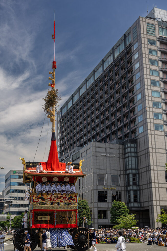 A Gion Matsuri hoko float turning ninety degrees at a Kyoto intersection