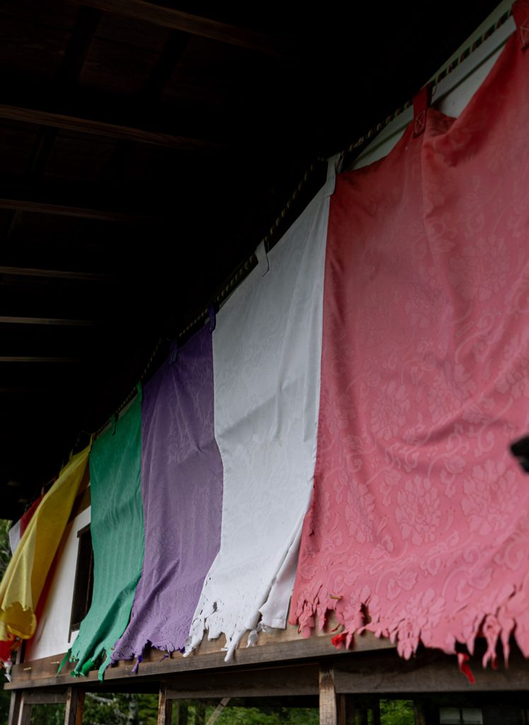 Weathered five-colored Buddhist banners hanging at Daihikaku Senkoji Temple in Kyoto
