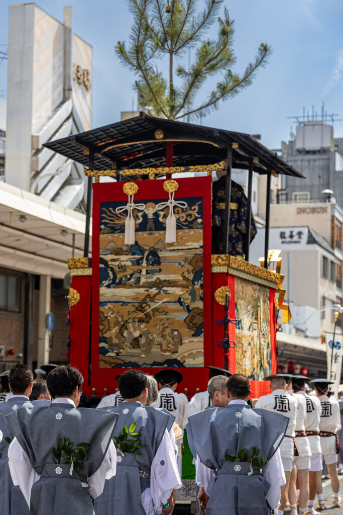 Rear tapestry of a Gion Matsuri yama float and its attendants in white