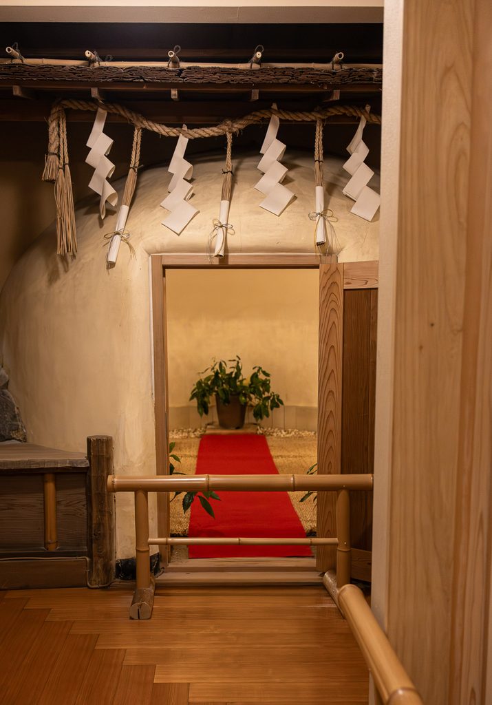 The kama-buro clay steam bath at Rurikoin, hung with a sacred Shinto rope