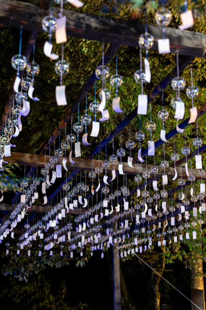 More than a thousand glass wind chimes glowing under blue light at night during Kamigamo Shrine's summer illumination