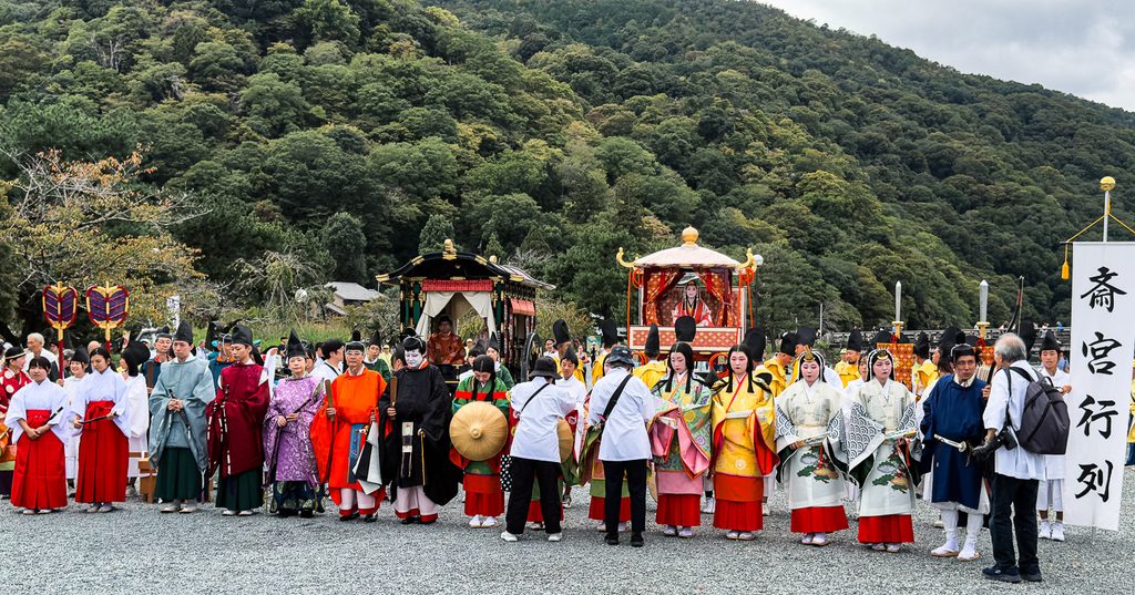 The full Saigu Gyoretsu procession assembled in period costume with the Arashiyama hills behind