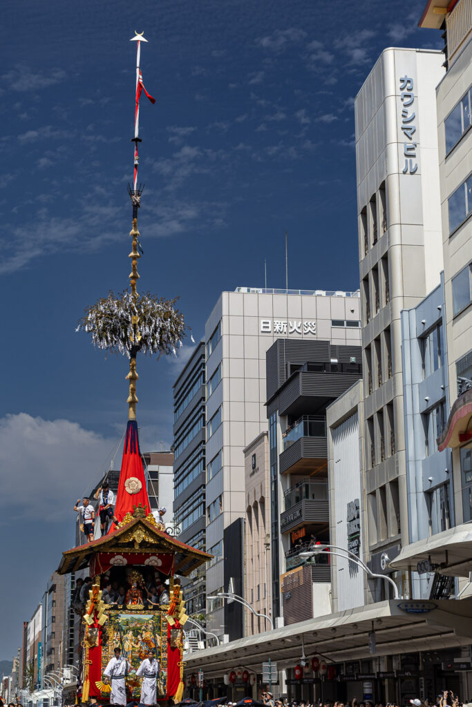 A Gion Matsuri hoko float and its tall central pole above Shijo Street