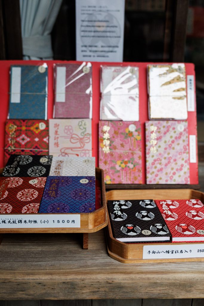 Goshuincho stamp books with dove crest design sold at Tamukeyama Hachimangu Shrine