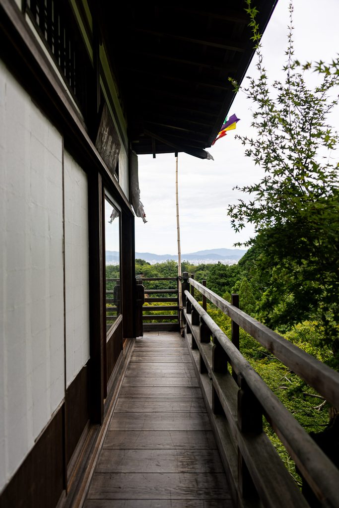 Wooden veranda of Daihikaku Senkoji Temple overlooking the mountains and the city of Kyoto