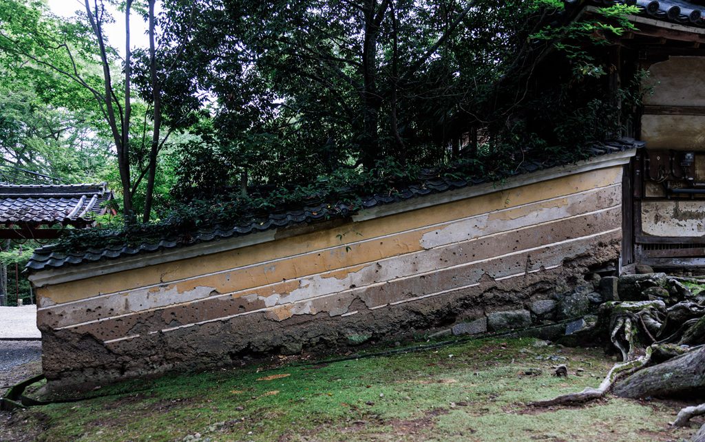 Peeling earthen tsuijibei wall showing layered construction at a Nara shrine