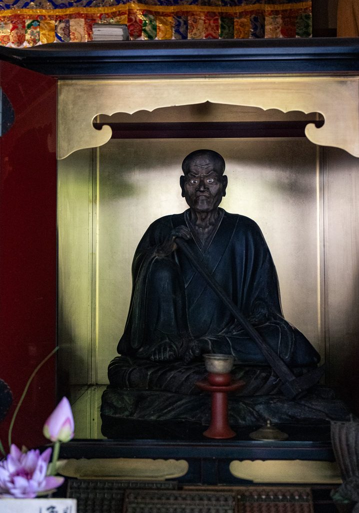 Wooden statue of Suminokura Ryoi, founder of Daihikaku Senkoji Temple, seated in a gilded shrine