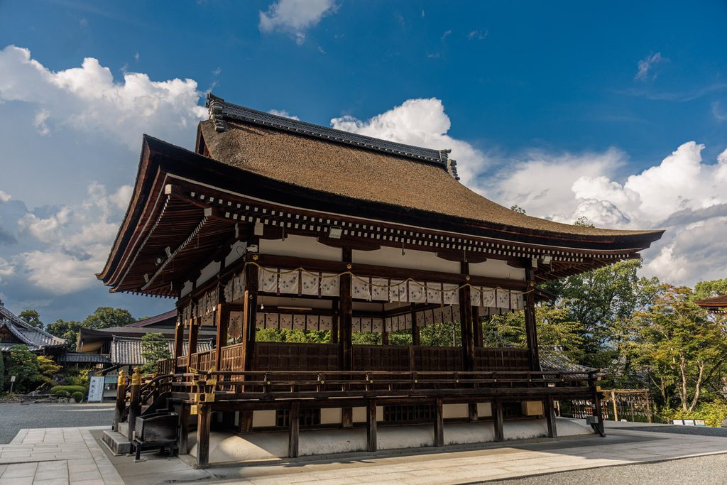 The open haiden worship hall of Matsuo Taisha under a summer sky