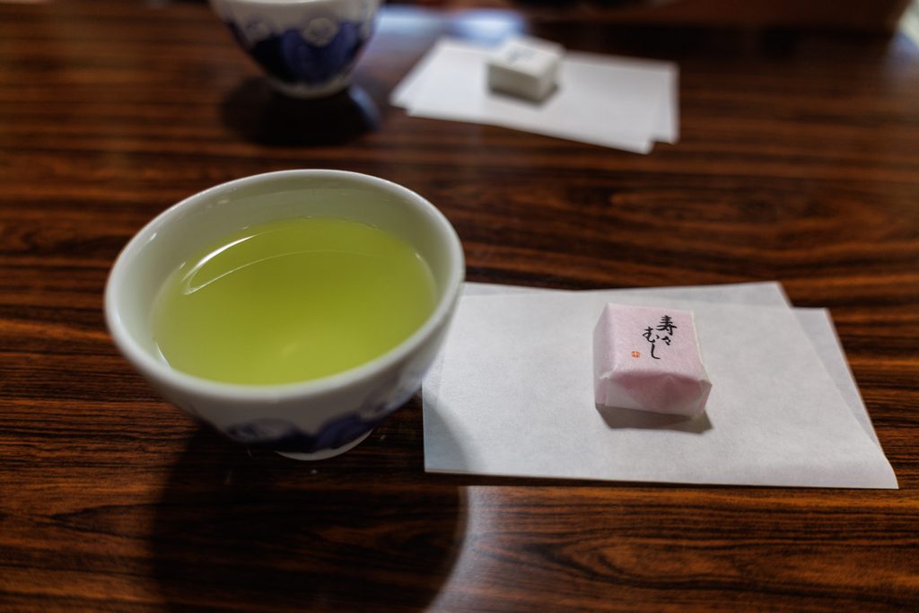 Cup of green tea and the wrapped suzumushi sweet served during the sermon at Suzumushi-dera Temple
