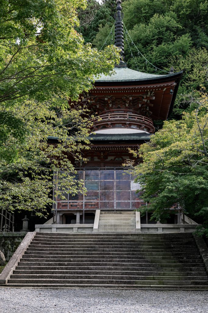 The two-storied pagoda of Horinji Temple rising among trees on the Arashiyama hillside