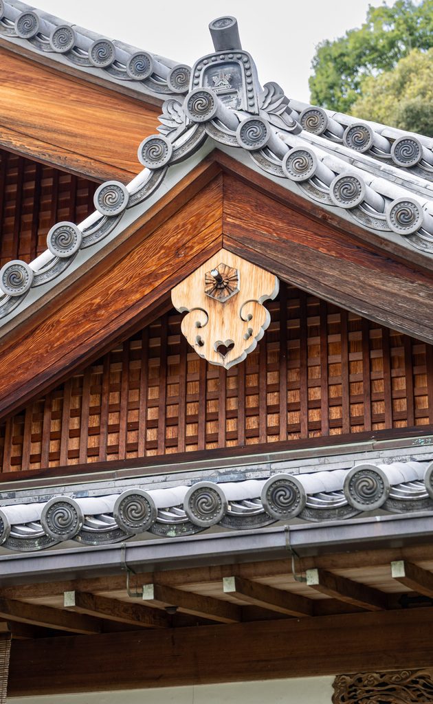 Carved gegyo gable ornament and tiled eaves at Kegon-ji, known as Suzumushi-dera Temple
