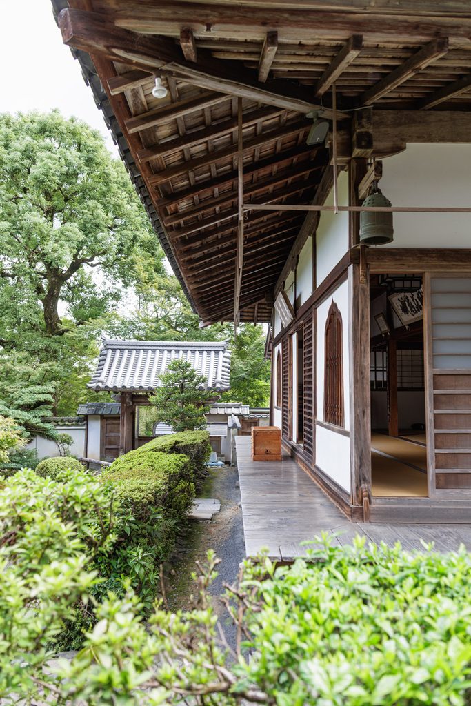 White wall and wooden veranda of the main hall at Suzumushi-dera Temple, a Rinzai Zen temple in Kyoto
