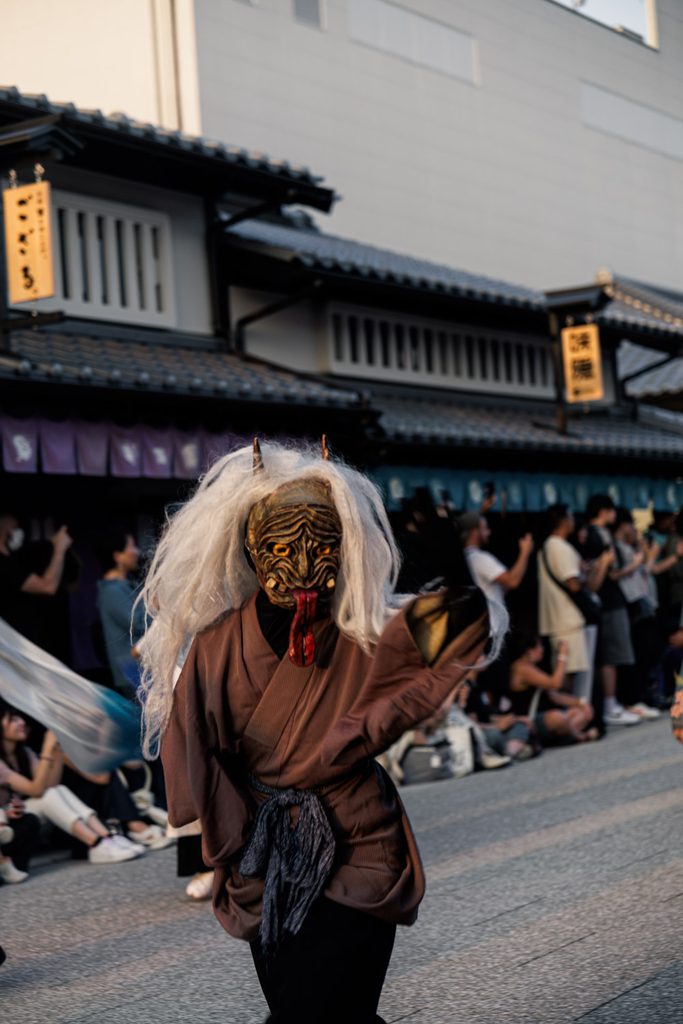 Yokai performer with long white hair and a red tongue at the Toei Kyoto Studio Park yokai festival