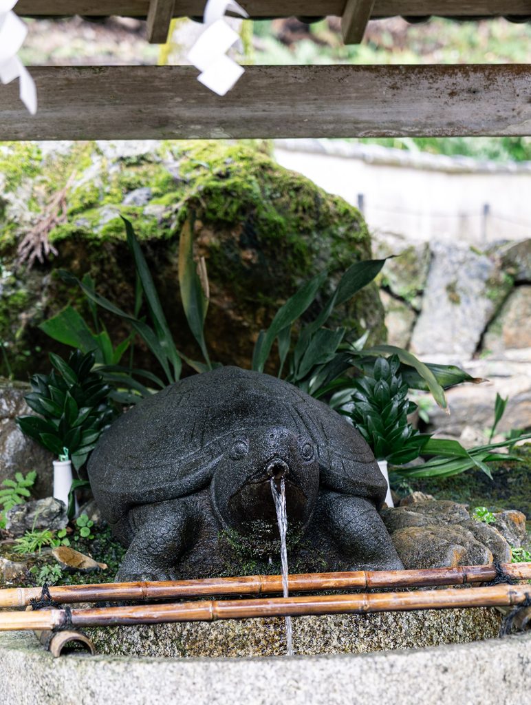 The stone turtle of Kame no I, the sacred spring at Matsuo Taisha, with water pouring from its mouth