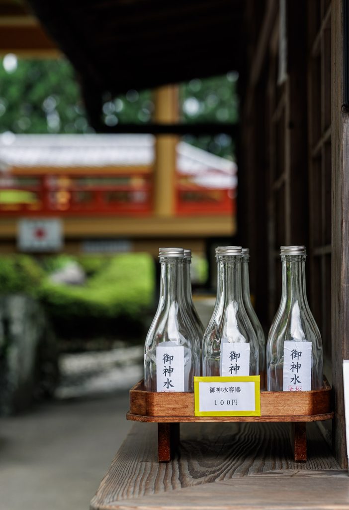Empty glass bottles sold for 100 yen to carry away the sacred water at Matsuo Taisha