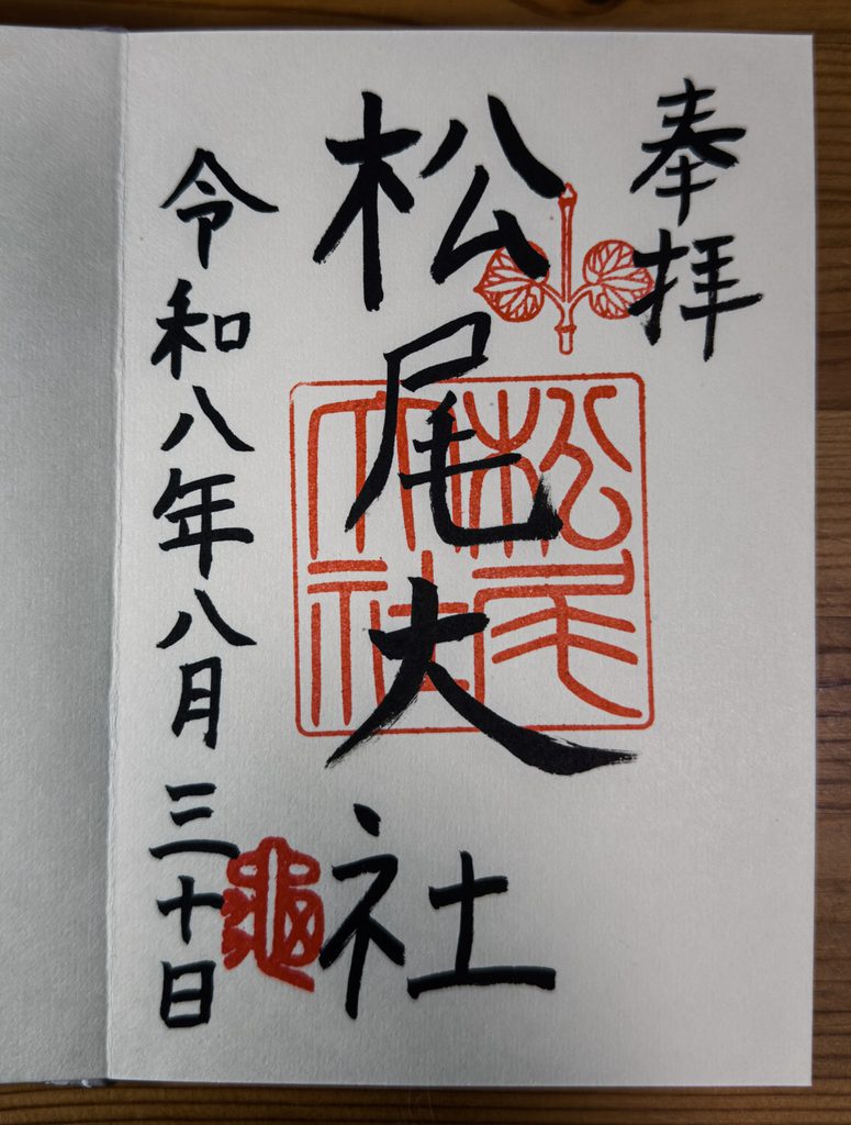A hand-written goshuin from Matsuo Taisha with the futaba-aoi crest stamped in red